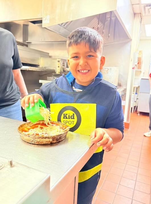 Children learning to cook in a fun, supervised kitchen class